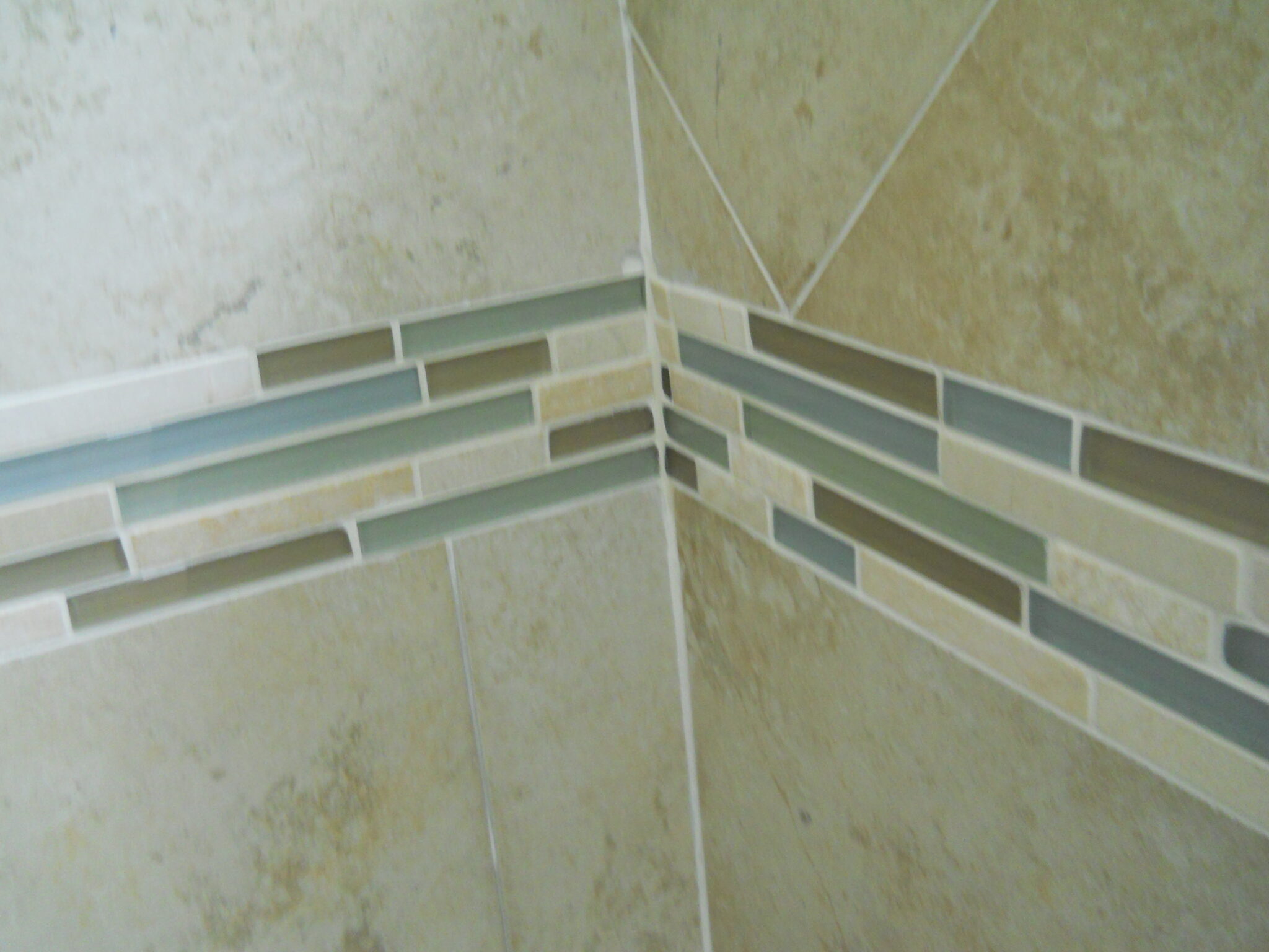 Decorative inlay with new backsplash tile in Raleigh home