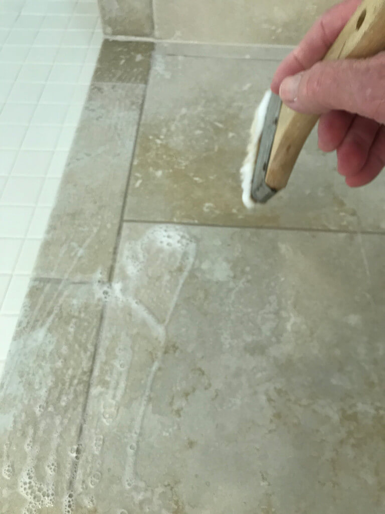 Applying high quality sealer to bathroom tiles and grout
